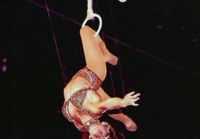 Dolly Jacobs performs a knee hang on the Roman Rings