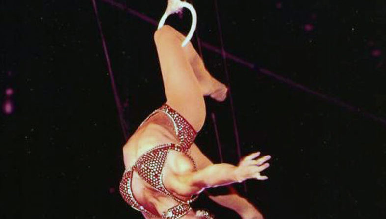 Dolly Jacobs performs a knee hang on the Roman Rings