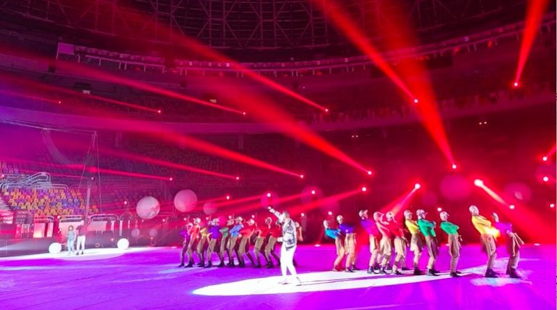 Cirque Éloize performers take the stage at the men's handball championship, with red and purple lights flooding the stage