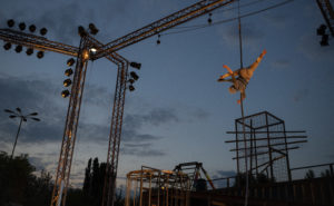 An aerialist on free ropes, suspended from the lighting truss of the WeLAND stage