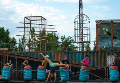 7 acrobats perform on the industrial-esque stage of WeLAND