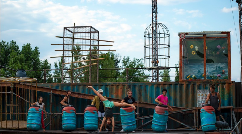 7 acrobats perform on the industrial-esque stage of WeLAND