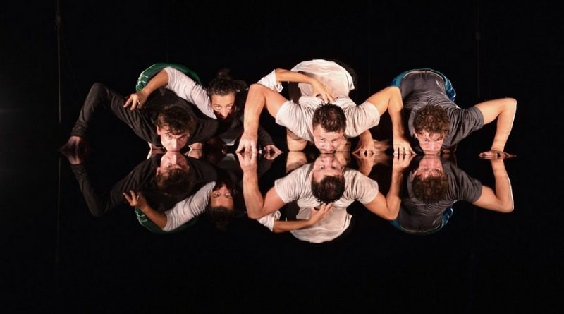 Performers bend over mirrors in the show "Surface," by Familiar Faces-Circustalk