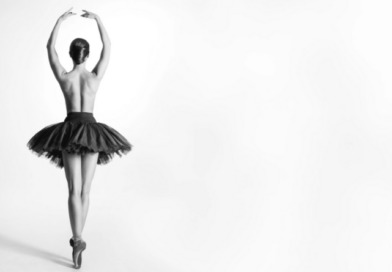 Artistic athlete: a ballerina, en pointe, with her back to the camera.