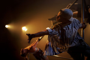 Johnny Brown reaches out while hanging on apparatus