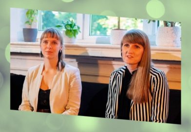 Liene Perkone and Mara Pavula sit side-by-side in front of a window