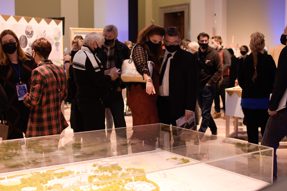 Guests at the Circus Buildings in Europe exhibit explore the room and point at a circus diorama