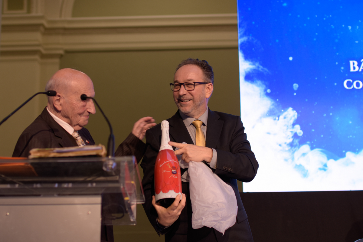 Peter Fekete and Alain Frere toast circus buildings history over a bottle of champagne