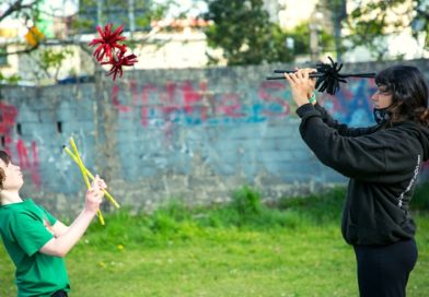 In Galway, Ireland, two social circus practitioners engage in game of devil sticks.