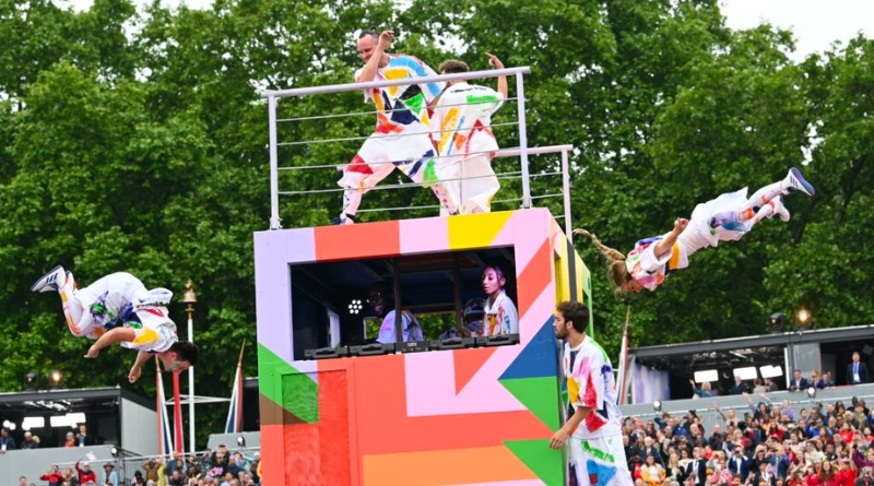 Cirque Bijou performers at the Queen's Platinum Jubilee Pageant. On a colorful box stage, the performers swing from ropes and trapezes