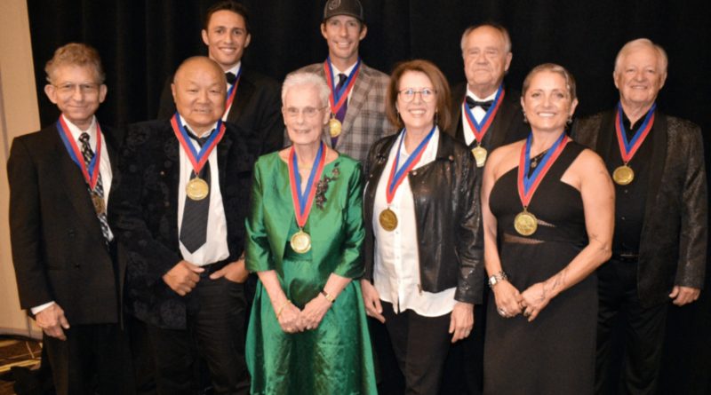 At the World Acrobatics Society's 2022 Hall of Fame Ceremony, the nine inducted athletes and performers wear their medals for a group photo
