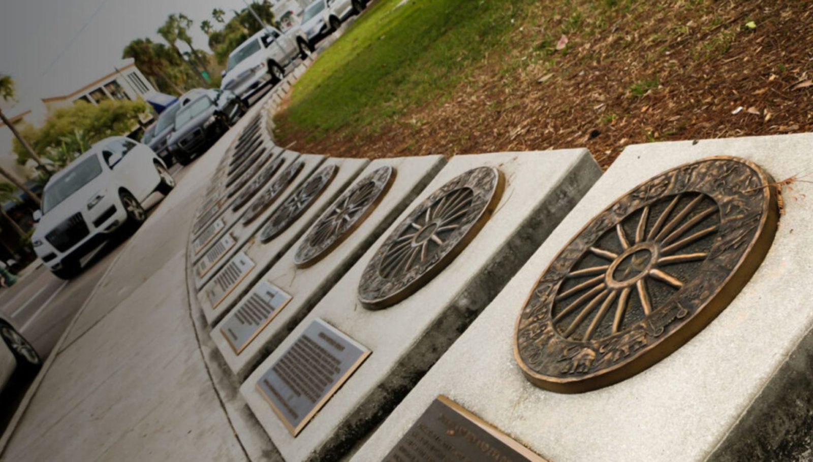 Circus Ring of Fame plaques to notable figures in the circus world. The plaques are laid out on a ring-shaped path beside a grassy field and parking lot