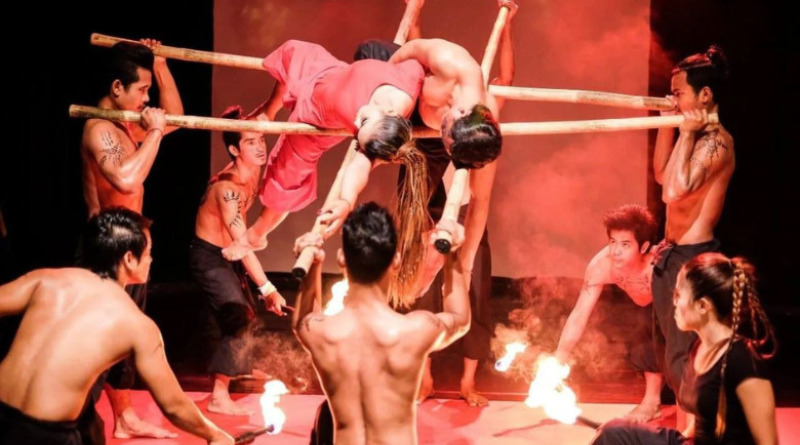 Phare Ponleu Selpak acrobats perform an act with horizontal bars and fire