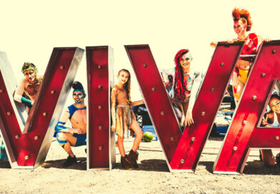 In Las Vegas, acrobats and circus performers surround the Viva sign of VIVA Fest