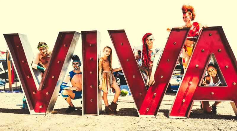 In Las Vegas, acrobats and circus performers surround the Viva sign of VIVA Fest
