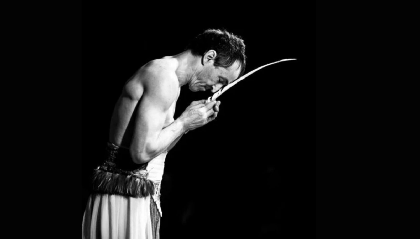 Swiss performer Martin "Mädir" Eugster of the Rigolo Circus does a balancing act with a long, thin blade