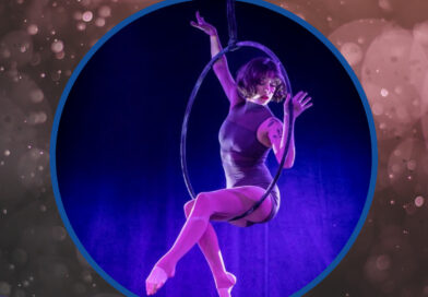 Aerialist Kalista Russelll, the 2023 VIVA Fest Emerging Aerial Hoop winner, perches gracefully on her lyra while performing her VIVA act