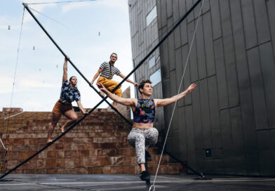 Three female acrobats climb a massive sculpture in One Fell Swoop Circus' "In Common"